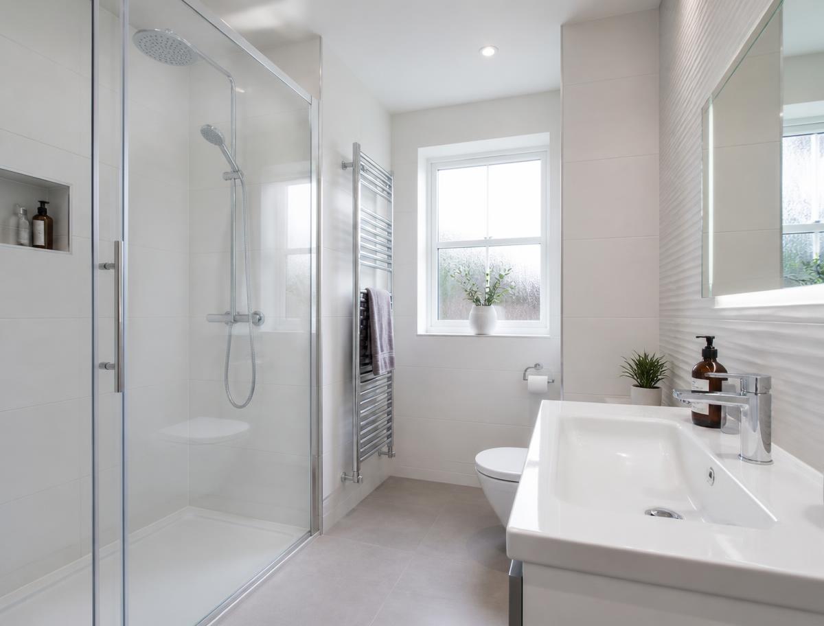 Sparkling clean bathroom with polished chrome taps and clear shower glass