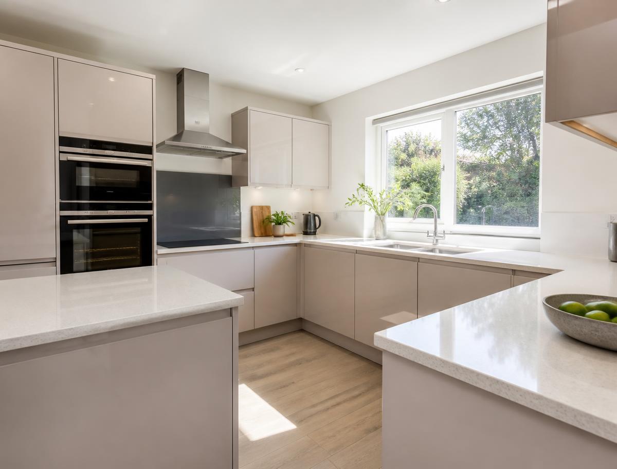 Bright spotless kitchen with gleaming worktops after a professional clean